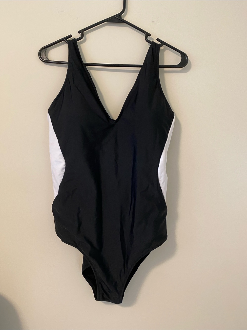 Black One-Piece Swimsuit with White Side Panels and surprising back detail.